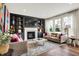 Cozy living room featuring a fireplace, built-in shelves, and comfortable seating, creating an inviting atmosphere at 14817 Deerwood Dr, Carmel, IN 46033