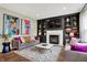 Comfortable living room with stylish sofas, fireplace, and large colorful artwork on the wall at 14817 Deerwood Dr, Carmel, IN 46033