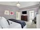 Spacious main bedroom with a mounted TV, dresser, and lots of natural light at 14817 Deerwood Dr, Carmel, IN 46033