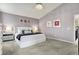 Bright main bedroom featuring a crystal chandelier, seating area, and neutral decor at 14817 Deerwood Dr, Carmel, IN 46033