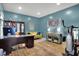 Bright office space with hardwood floors, ample natural light, a dark wood desk, and a comfortable seating area at 14817 Deerwood Dr, Carmel, IN 46033