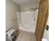 Bathroom featuring a tiled shower with towel bar and door on tiled floors at 1598 Commerce Way, Pittsboro, IN 46167