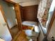 Bathroom featuring a tiled bath tub, shower, toilet, window, and wood flooring at 1598 Commerce Way, Pittsboro, IN 46167