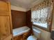Cozy bathroom featuring a tub, toilet, and window at 1598 Commerce Way, Pittsboro, IN 46167