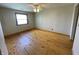 Bright bedroom featuring hardwood floors, a ceiling fan and natural lighting at 1598 Commerce Way, Pittsboro, IN 46167