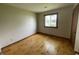 Bedroom featuring light walls, wood floors and a window at 1598 Commerce Way, Pittsboro, IN 46167