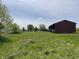 Spacious lot featuring a metal outbuilding, ideal for storage or workshop space at 1598 Commerce Way, Pittsboro, IN 46167