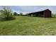 View of multiple spacious outbuildings on a well-maintained lot, offering plenty of storage at 1598 Commerce Way, Pittsboro, IN 46167