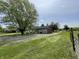 Exterior of home with a sprawling gravel driveway and lush lawn at 1598 Commerce Way, Pittsboro, IN 46167
