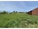 Sprawling lot with lush green grass and an outbuilding, perfect for outdoor enjoyment at 1598 Commerce Way, Pittsboro, IN 46167