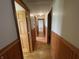 Hallway featuring wood floors and paneled walls at 1598 Commerce Way, Pittsboro, IN 46167
