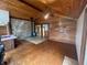 Living room with hardwood floors, wood ceilings, stone accent wall, and a wood burning stove at 1598 Commerce Way, Pittsboro, IN 46167
