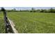 A vast, well-manicured green lawn enclosed by a rustic wooden fence at 1598 Commerce Way, Pittsboro, IN 46167