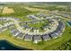 An aerial view shows a new neighborhood with modern homes arranged in a circular street pattern at 17023 Adler Ln, Noblesville, IN 46060