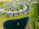An aerial view of new homes in a neighborhood situated around a pond with a fountain at 17023 Adler Ln, Noblesville, IN 46060