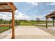Backyard featuring lake view, pergola, concrete patio, rock landscaping and green grass at 17023 Adler Ln, Noblesville, IN 46060