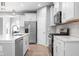 Modern kitchen with white cabinetry, stainless steel appliances, and quartz countertops at 17023 Adler Ln, Noblesville, IN 46060