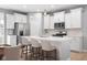 Bright, modern kitchen featuring an island with seating, stainless steel appliances, and stylish pendant lighting at 17023 Adler Ln, Noblesville, IN 46060
