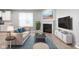 Cozy living room featuring a fireplace, plush seating, and natural light from a large window at 17023 Adler Ln, Noblesville, IN 46060