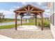 Pergola with ceiling fan on a concrete patio overlooking a pond and green grass at 17023 Adler Ln, Noblesville, IN 46060