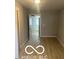 A bedroom featuring vinyl flooring, a window, and open door at 1710 S Birch St, Muncie, IN 47302