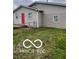 This home features a well-maintained exterior with a vibrant red door and neatly landscaped surroundings at 1710 S Birch St, Muncie, IN 47302