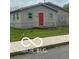 Charming home featuring light siding, fenced front yard, and a red front door at 1710 S Birch St, Muncie, IN 47302