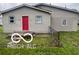 Charming single-story home features a red door and fenced front yard at 1710 S Birch St, Muncie, IN 47302