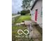 Charming home exterior featuring a fenced yard, welcoming entrance and a vibrant red door at 1710 S Birch St, Muncie, IN 47302