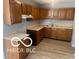 Functional kitchen features light countertops, hardwood floors, and wood cabinets at 1710 S Birch St, Muncie, IN 47302