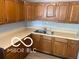 A well-lit kitchen featuring wooden cabinets and light countertops at 1710 S Birch St, Muncie, IN 47302