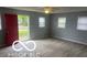 Bright living room featuring hardwood floors, neutral paint, and ample windows at 1710 S Birch St, Muncie, IN 47302