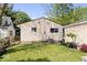 Home's backyard with a green lawn, plants, and the exterior of the home at 1715 Haynes Ave, Indianapolis, IN 46240