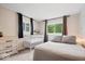 Cozy bedroom with neutral tones, two windows, and a crib at 1715 Haynes Ave, Indianapolis, IN 46240