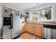 Functional kitchen featuring stainless steel appliances, wood cabinets, and a window over the sink at 1715 Haynes Ave, Indianapolis, IN 46240