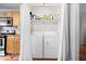 Laundry area tucked behind curtains, featuring a washer, dryer, and shelving at 1715 Haynes Ave, Indianapolis, IN 46240