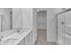 Bright bathroom featuring double vanity with white cabinets, quartz countertop, and glass-enclosed shower at 17344 Hanningfield Way, Westfield, IN 46074