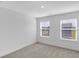 Light-filled bedroom with carpet, two windows, and neutral decor at 17344 Hanningfield Way, Westfield, IN 46074