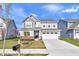 Charming two-story home featuring a two-car garage, well-manicured lawn, and welcoming entrance at 17344 Hanningfield Way, Westfield, IN 46074