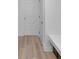 Hallway with laminate flooring, white doors, and a sleek bench at 17344 Hanningfield Way, Westfield, IN 46074