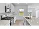 A modern, well-lit kitchen with granite countertops and stainless steel appliances at 17344 Hanningfield Way, Westfield, IN 46074