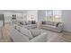 Open-concept living room and kitchen with hardwood floors and modern furniture at 17344 Hanningfield Way, Westfield, IN 46074