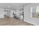 A kitchen with granite countertop island opens into an open-concept space with a living room area at 17344 Hanningfield Way, Westfield, IN 46074