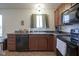 Kitchen featuring stainless sink, wood cabinetry, black appliances and tile floors at 1739 Elderberry Dr, Indianapolis, IN 46234
