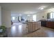 Open-concept kitchen and living area with an island, wooden cabinets, and tile flooring at 1739 Elderberry Dr, Indianapolis, IN 46234