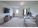 Spacious living room with plush carpet, comfortable seating, and a mounted flat-screen TV at 1739 Elderberry Dr, Indianapolis, IN 46234