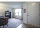 Bright living room with neutral carpet, large window, and a view of the entry door at 1739 Elderberry Dr, Indianapolis, IN 46234