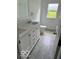 New bathroom with double vanity, toilet, and window that overlooks the yard and greenery at 1945 Plantation Ln, Martinsville, IN 46151