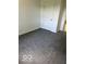 Empty bedroom features gray carpet and a door at 1945 Plantation Ln, Martinsville, IN 46151