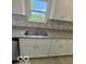 Updated kitchen with granite counters, white cabinets, and a view at 1945 Plantation Ln, Martinsville, IN 46151